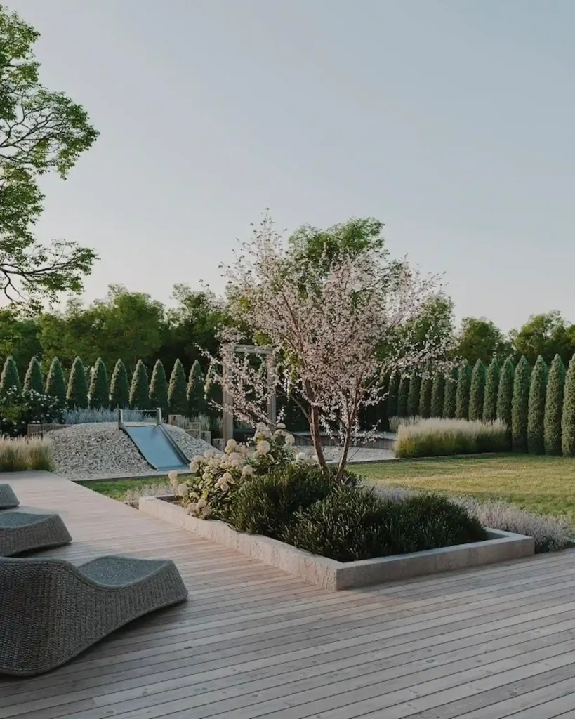 Garden terrace with deck, lawn, planting beds and outdoor lounge area